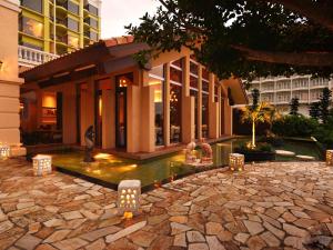 a building with a fountain in front of a building at Okinawa Kariyushi Resort EXES Onna in Onna