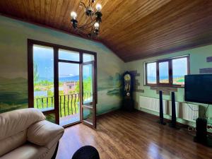 a living room with a couch and a balcony at Rancho by HV in Sevan