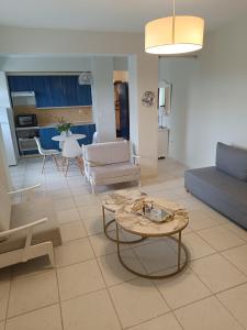 a living room with a couch and a table at Olive & Garden in Nea Moudania