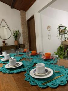 a table with plates and cups on top of it at Suites Casa De Ban in Lençóis +36 photos