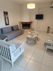 a living room with a couch and a table at Olive & Garden in Nea Moudania