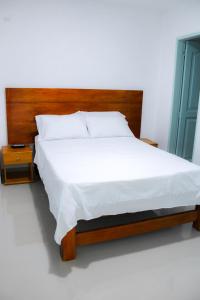 Postel nebo postele na pokoji v ubytování Hotel San Andres Arboletes