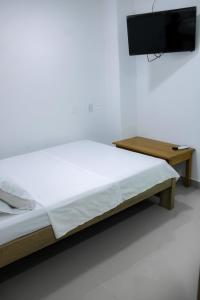 Postel nebo postele na pokoji v ubytování Hotel San Andres Arboletes