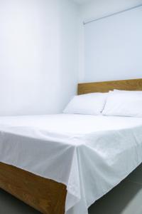 Postel nebo postele na pokoji v ubytování Hotel San Andres Arboletes