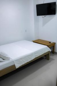 Postel nebo postele na pokoji v ubytování Hotel San Andres Arboletes