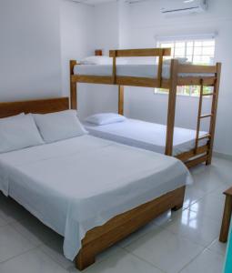 Postel nebo postele na pokoji v ubytování Hotel San Andres Arboletes
