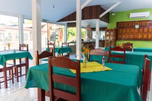 a dining room with blue tables and chairs at Hotel Coração Verde in Alter do Chao