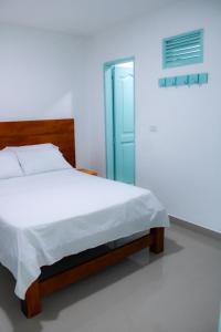 Postel nebo postele na pokoji v ubytování Hotel San Andres Arboletes