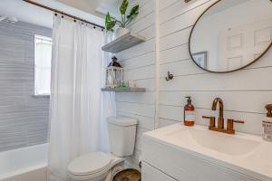 a bathroom with a toilet and a sink and a mirror at Lovely Retreat Walk to Manasota Key Beach! in Englewood +24 photos