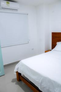 Postel nebo postele na pokoji v ubytování Hotel San Andres Arboletes