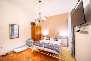 a bedroom with a bed and a flat screen tv at Rooms Nona Albina in Rab