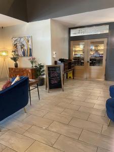 a lobby with a restaurant with a sign on the floor at Plantation Inn in Houma