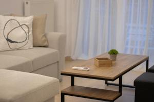 a living room with a couch and a coffee table at La Femme Apartment in Chrysoupolis