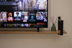 a flat screen tv sitting on top of a shelf at La Femme Apartment in Chrysoupolis