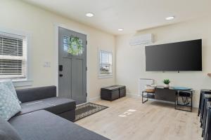 a living room with a couch and a flat screen tv at half Mi to Ocean Copalis Beach Hideaway! in Copalis Beach