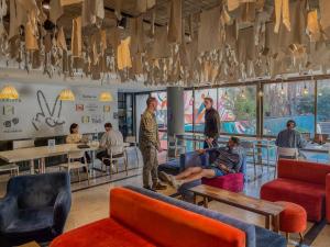 a group of people in a room with chairs and tables at Viajero Buenos Aires Hostel in Buenos Aires