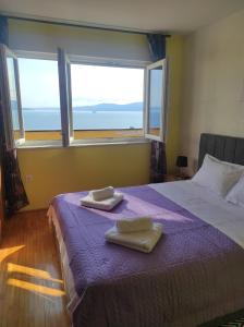 a bedroom with a bed with two towels on it at Apartman Yuriel - Sea View in Rijeka