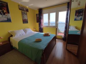 a bedroom with a bed and a large window at Apartman Yuriel - Sea View in Rijeka +36 photos