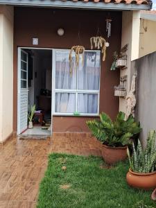 a front door of a house with plants in the yard at Casa Primavera in Holambra