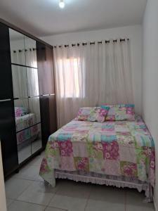 a bedroom with a bed and a dresser at Casa Primavera in Holambra