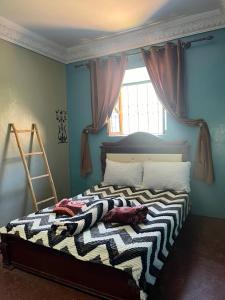 a bed with two pillows on it in a room at da housa hostel in Tahliouine