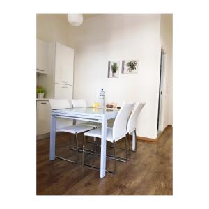a white dining room table with white chairs at Dimora Azzurra in Porto SantʼElpidio