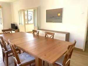 a dining room with a wooden table and chairs at Casa Patrón in Costa da Caparica +22 photos