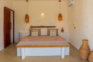 a bedroom with a large bed in a room at Araxá Milagres in São Miguel dos Milagres