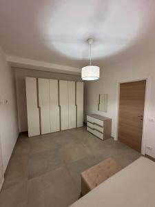 an empty room with a closet and a table at Summertime's House in Peschici
