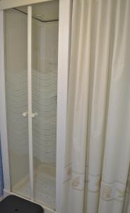 a shower with a white curtain in a bathroom at La maison d'Arthur et Armelène in Rely +18 photos