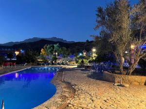 a swimming pool in a resort at night at Auberge Alwahabi in Chefchaouen