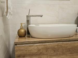 a white sink on a wooden counter in a bathroom at Il Vento in Split