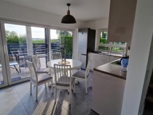 a kitchen and dining room with a table and chairs at Villa Lago am Plauer See in Alt Schwerin
