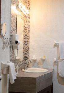 a bathroom with a sink and a mirror at El Marques Hacienda in Guanajuato