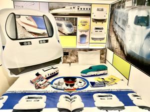 a room with a bed in a train room at Henn na Hotel Osaka Shinsaibashi in Osaka