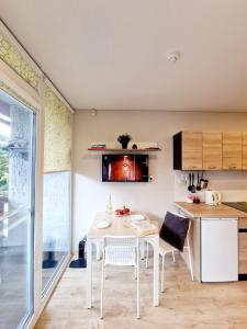 a kitchen with a table and chairs in a room at Good Vibes :) in Juodkrantė