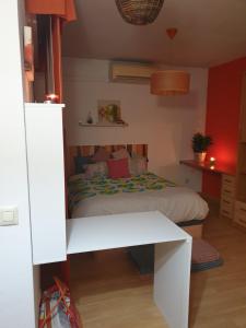 a small bedroom with a bed and a table at DOGGY House&hosting DOGS&FAMILY in Parla