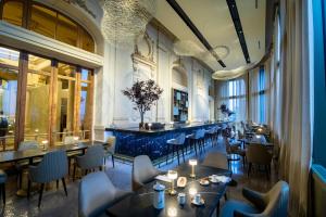 a restaurant with tables and chairs in a room at Sofitel Montevideo Casino Carrasco & Spa in Montevideo
