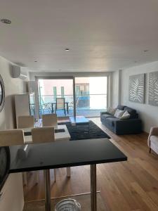 a living room with a couch and a table at Tropical Paradise at Luxurious Ocean Village in Gibraltar