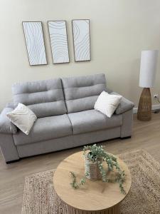 a living room with a couch and a table at Playa América-Sal y Arena in Nigrán