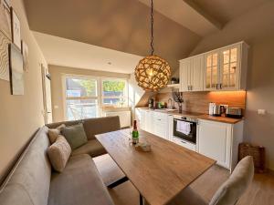 a living room with a couch and a table at Ferienanlage Eldena Ferienwohnung 12 in Lobbe