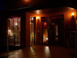 an entrance to a restaurant at night at Villa Stylius in Gdańsk