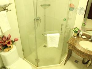 a bathroom with a shower and a toilet and a sink at GreenTree Alliance Zhejiang Zhoushan Haitian Avenue West Donghai Road Hotel in Zhoushan