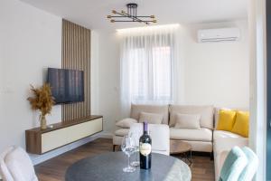 比耶洛波列North Apartments的客厅配有沙发和一张桌子及一瓶葡萄酒