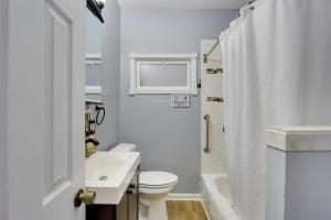 a white bathroom with a toilet and a shower at Jersey City Apartment Near Liberty State Park in Jersey City +21 photos