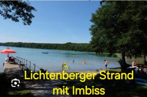 a group of people swimming in the water at a lake at Mietwohnwagen in Carpin +4 photos