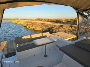 a view from the back of a boat on a river at COMPORTA SIDE - Boat in Setúbal