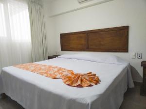 a bedroom with a bed with a bow on it at Departamento Caracol in Puerto Vallarta