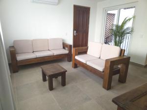 a living room with two chairs and a table at Departamento Caracol in Puerto Vallarta
