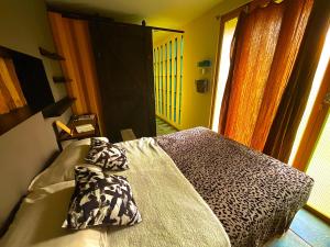 a bedroom with a bed with a leopard print at Container House in Tlayacapan +10 photos